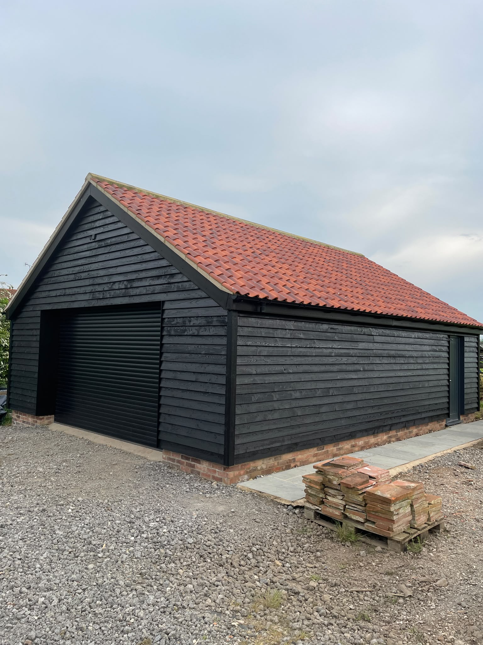 Garage cladding: detached garage clad and sprayed black to match the main house