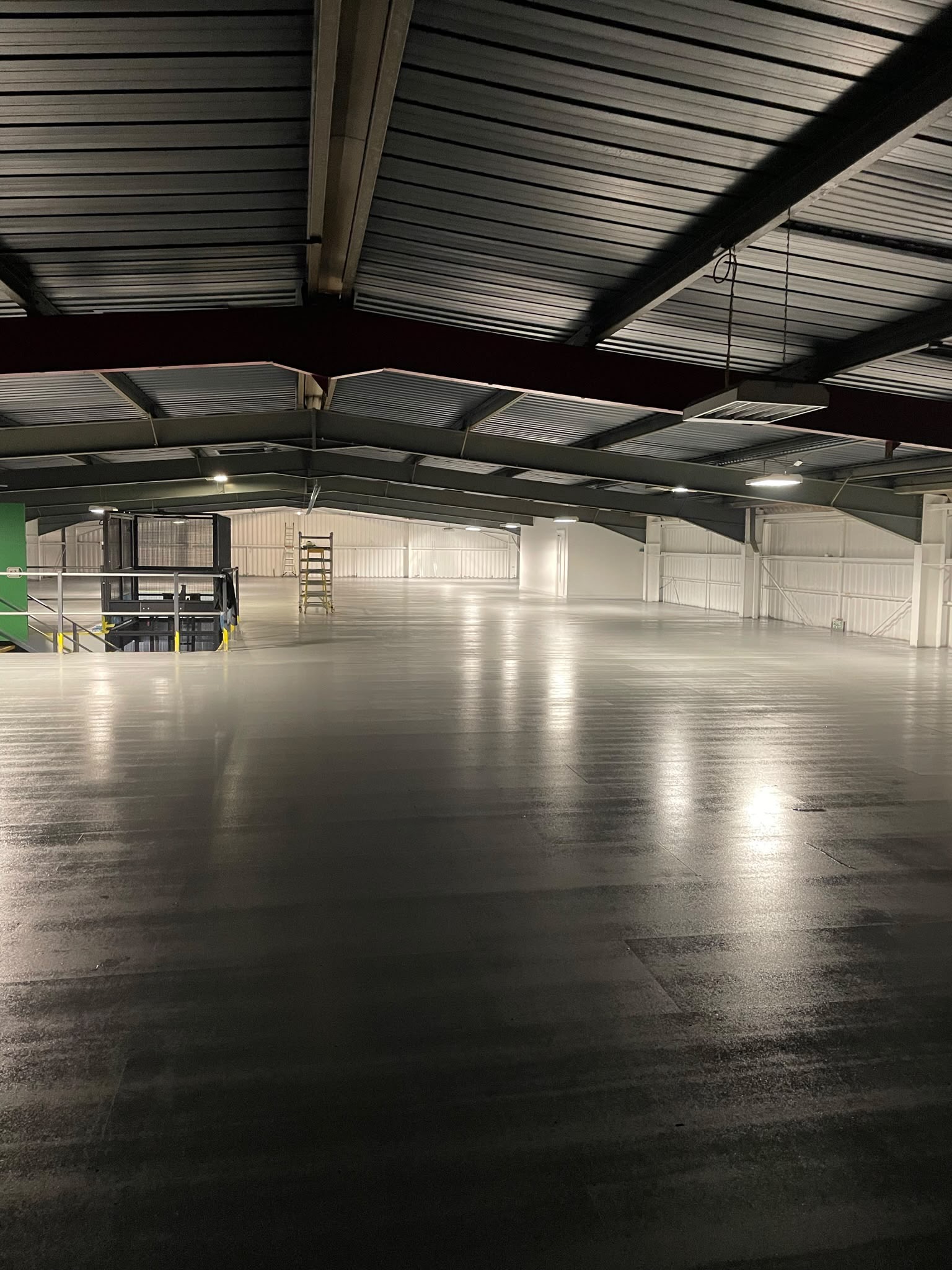 Internal spraying: warehouse roof sheets and floor sprayed grey