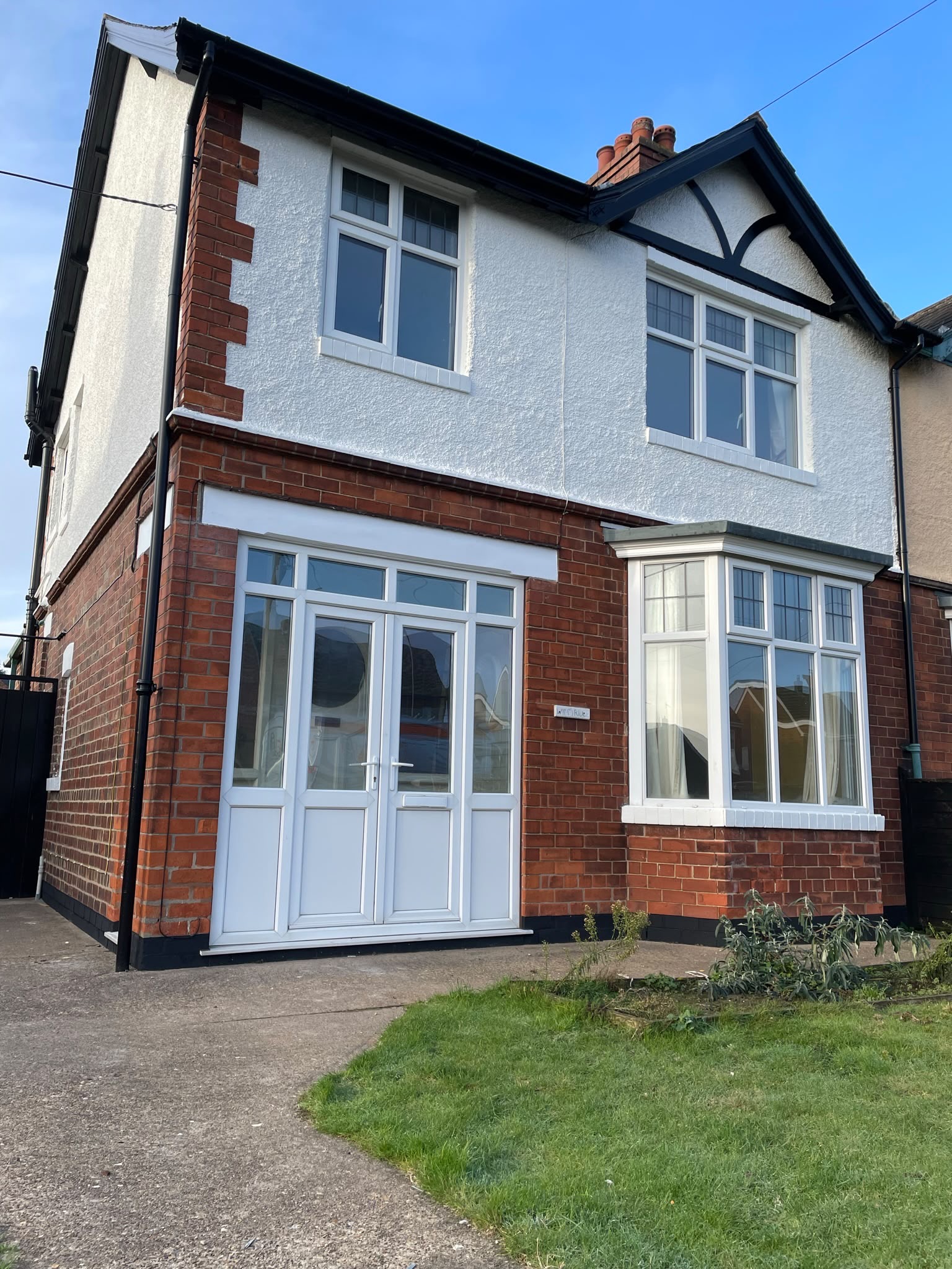 Home exterior spraying: bay, window frames and render refreshed on a semi detached house