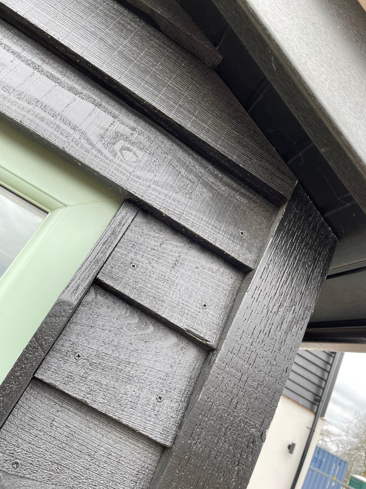 UPVC spraying: white fascia and trim recoloured slate grey on a house