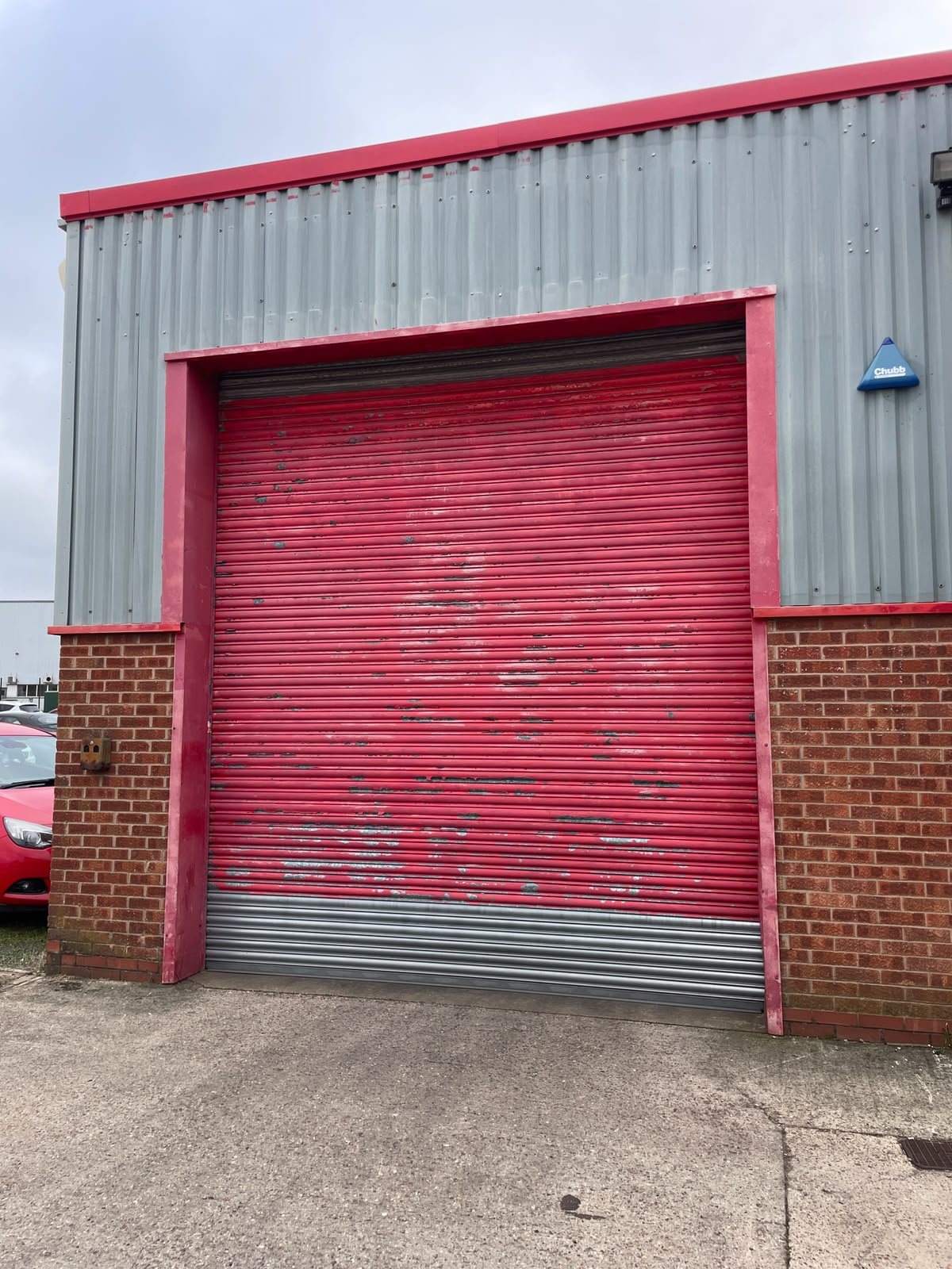 Roller shutter spraying: weathered commercial roller shutters before and after a respray. Before.